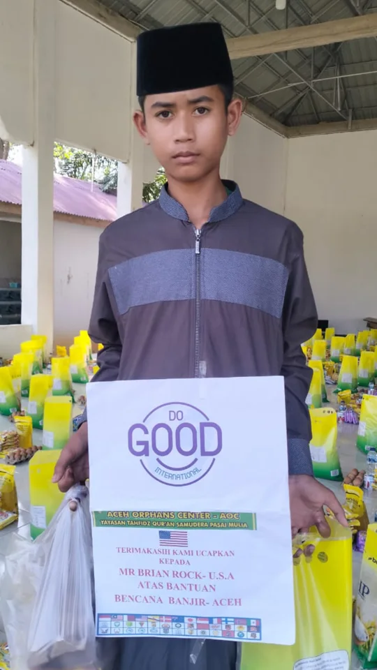 Community member holding DO GOOD materials in Sumatra