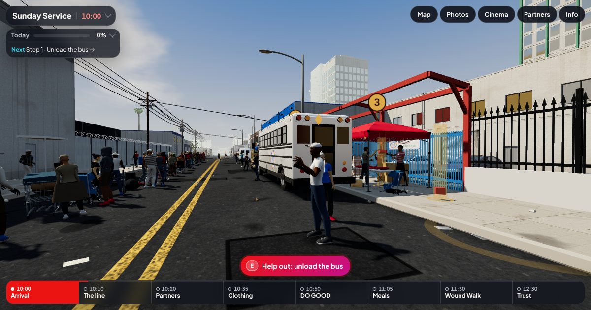 The game: a volunteer stands by the DO GOOD bus on Towne Avenue, with the line of people behind and the goal for the day at the top left